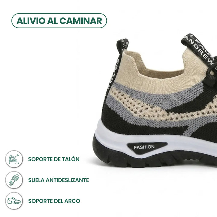 Close-up of a knit mesh sneaker's heel in black, gray and beige, showing the pull tab and thick white and black tread sole. 40