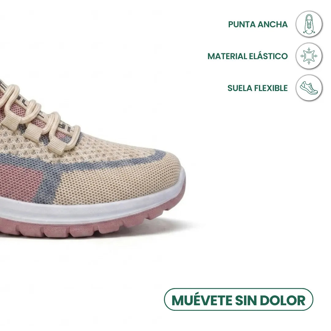 Close-up of the wide toe box of a beige mesh sneaker with pink and blue panels, pink flexible sole, and feature icons. 32