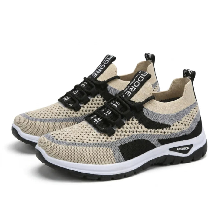 Pair of beige knit mesh sneakers with gray and black accents, black laces and a white sole, shown at an angle. 43