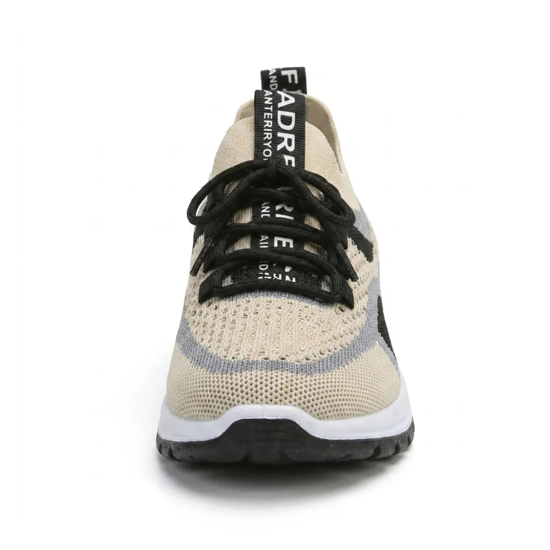 Front view of a beige mesh sneaker with black laces, gray and black side stripes, a pull tab and a white sole. 44