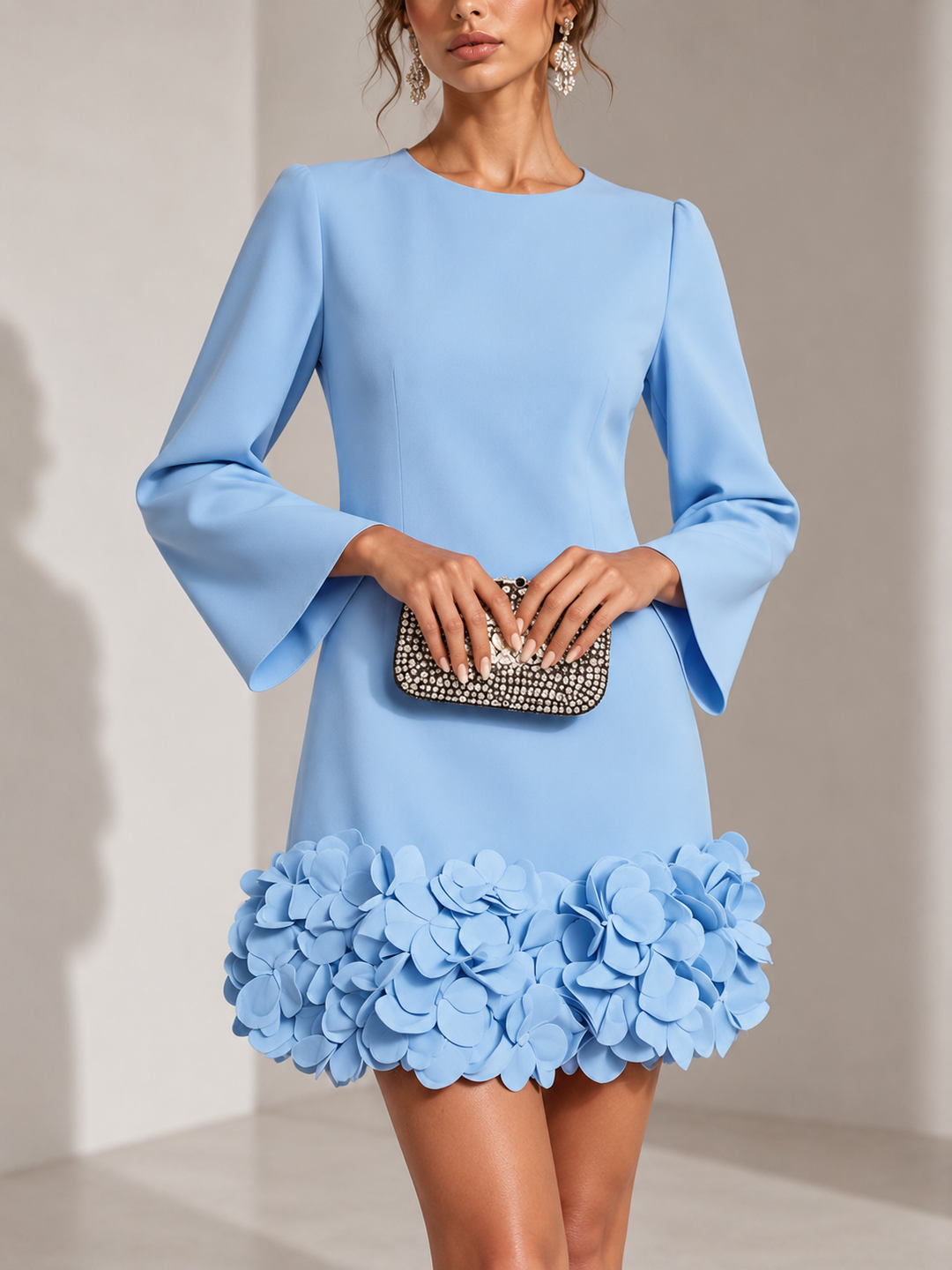Light blue dress with flared long sleeves and a dimensional petal hem, shown from the front.