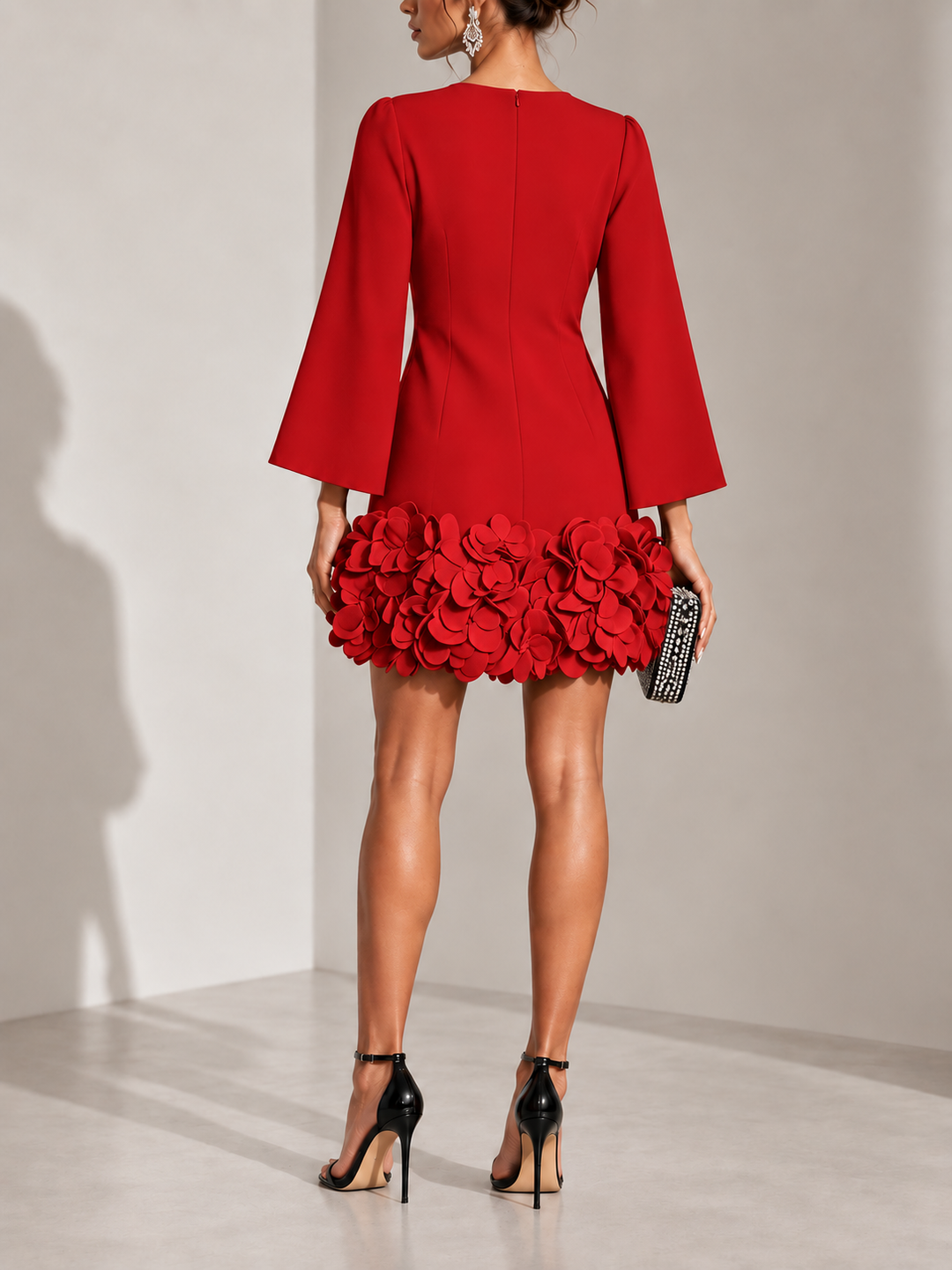 Red dress another view showing the center zipper, waist seams and thick petal trim at the hem.