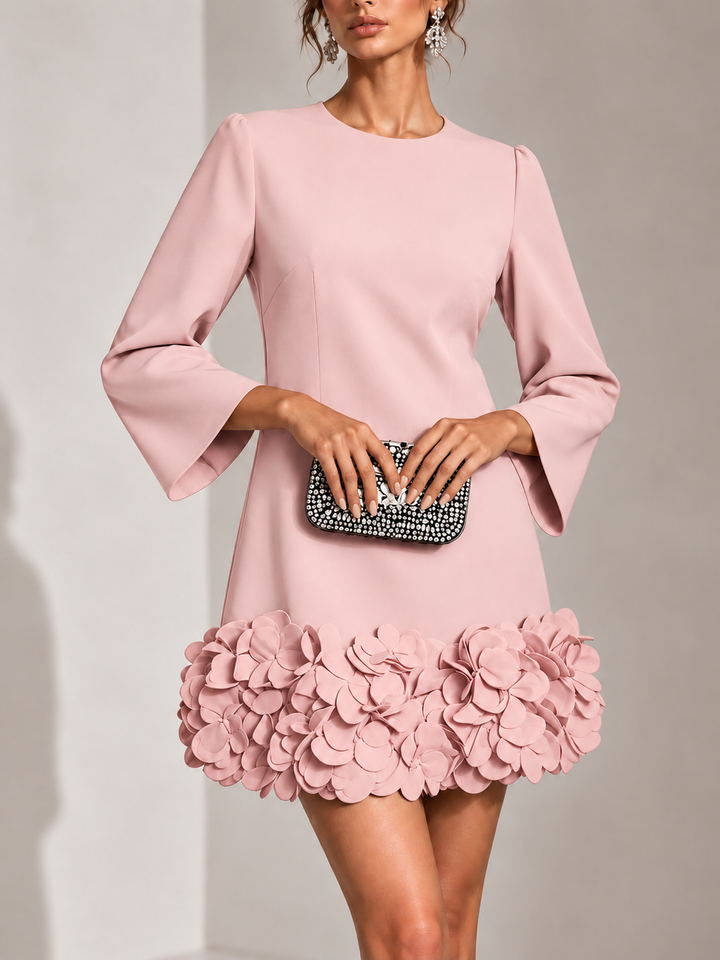 Pink dress with flared long sleeves and a layered petal hem, shown from the front.