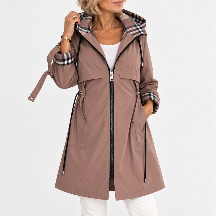 Woman wearing the mocha-brown hooded coat unzipped, one hand lifting the plaid-lined hood, with a cinched waist 1