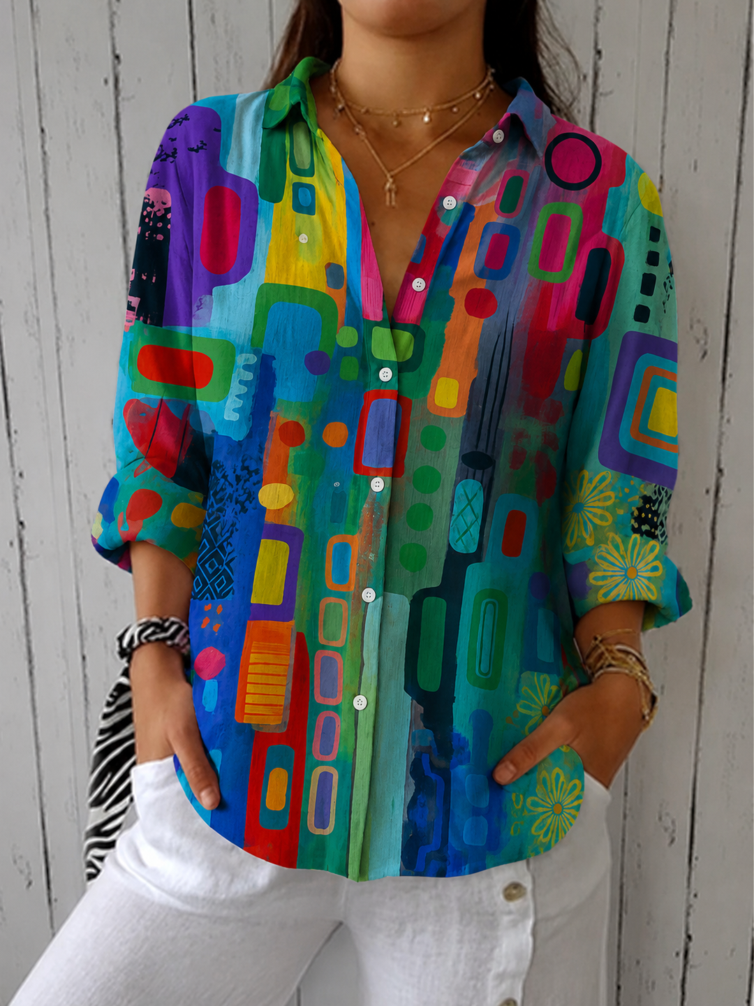 Front view of the multicolor green, blue and magenta blouse with collar open and sleeves rolled.