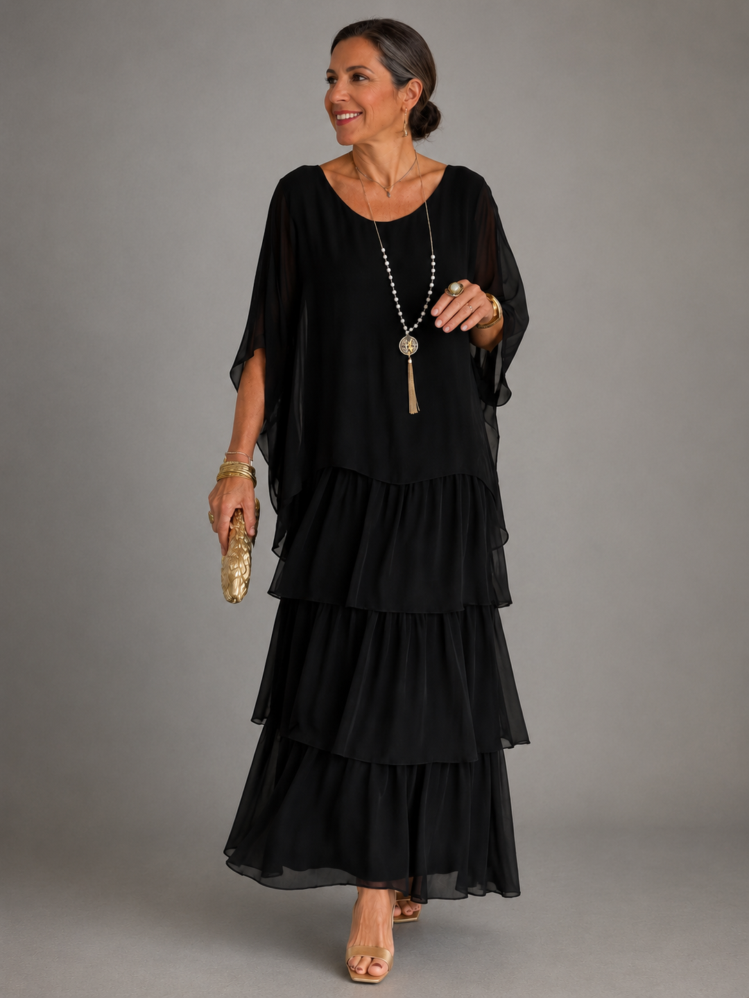 Green tiered chiffon maxi dress with a sheer cape overlay