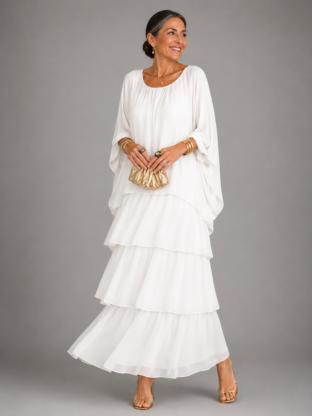White tiered chiffon maxi dress with a gathered neckline and flowing cape sleeves