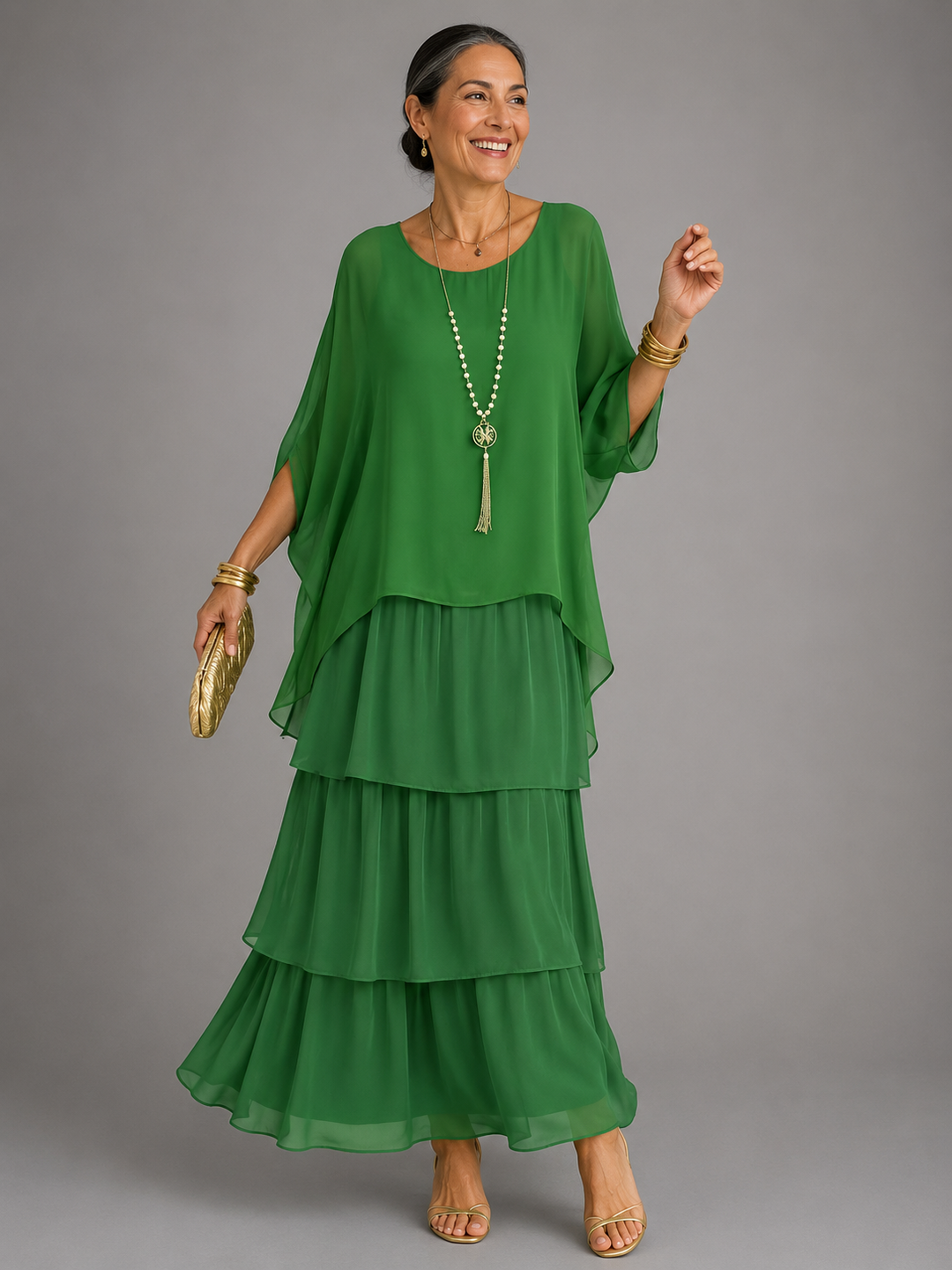 Emerald green tiered chiffon maxi dress with a sheer cape top