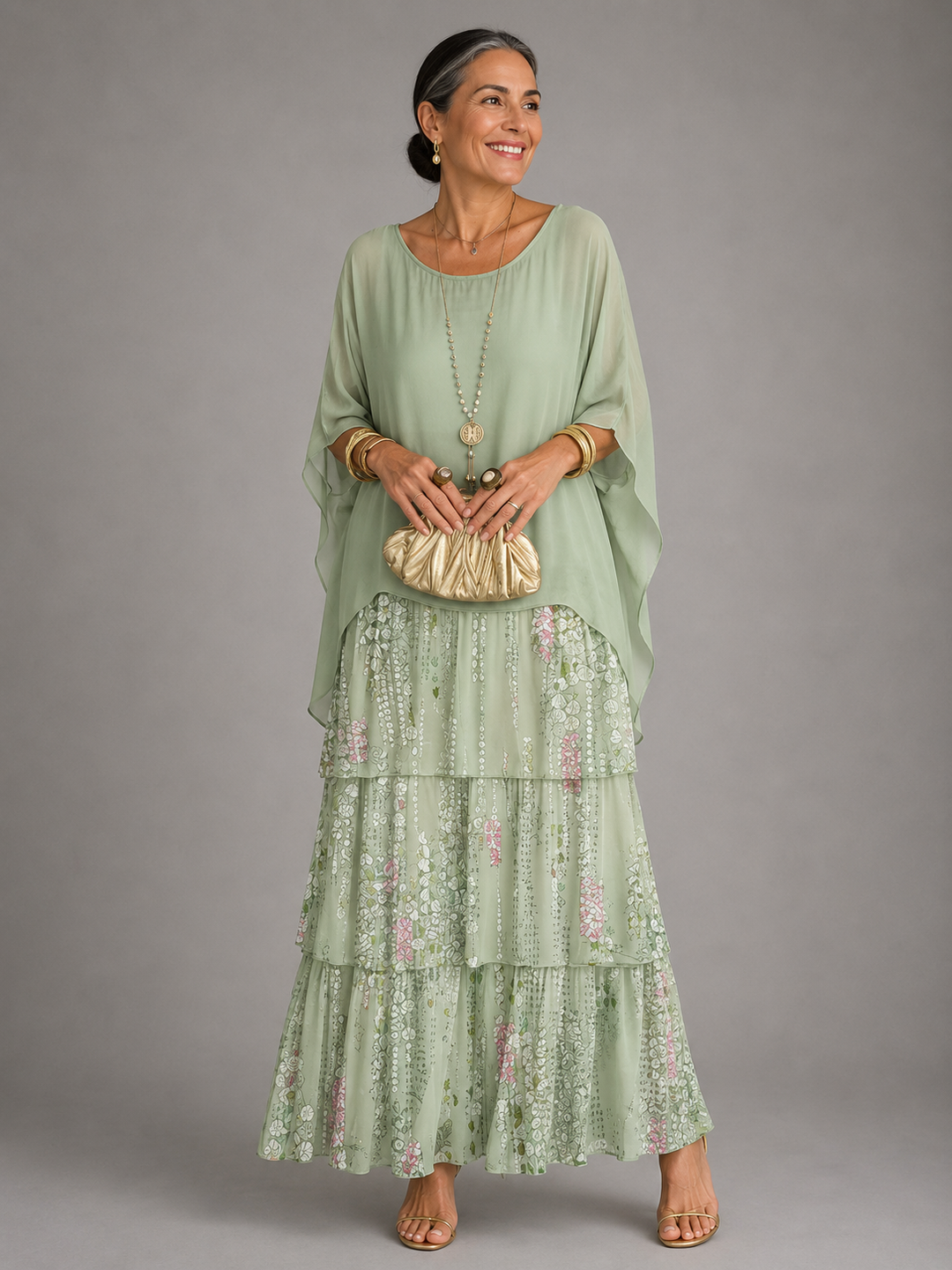 Maxi dress with a pale green cape top over a tiered skirt in a soft green and pink floral print