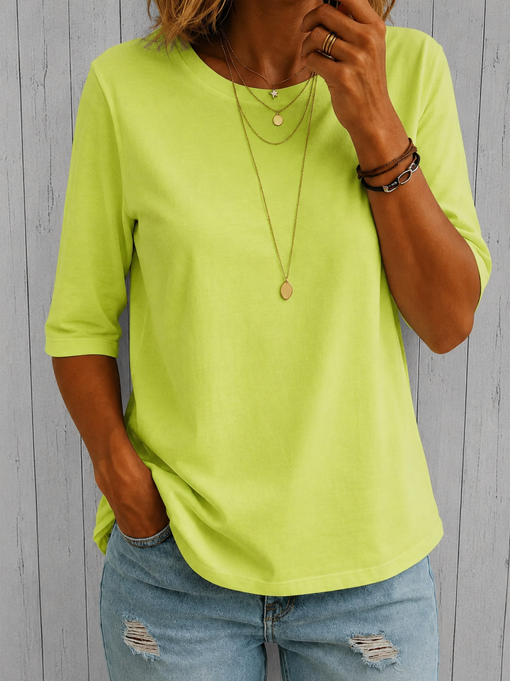Bright lime-yellow half-sleeve tee with a crewneck and layered gold necklaces, another view.