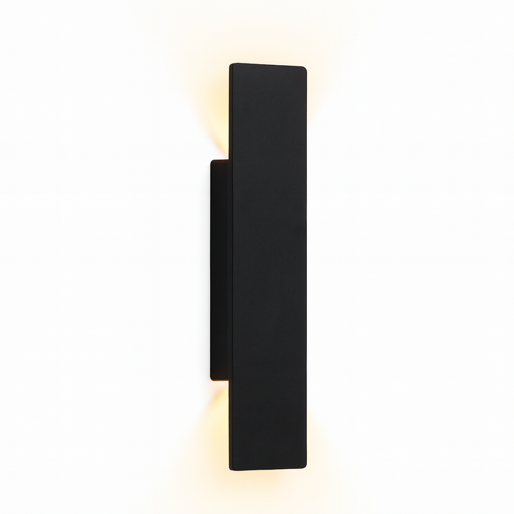 Black aluminium wall sconce with warm up and down light, shown at an angle.