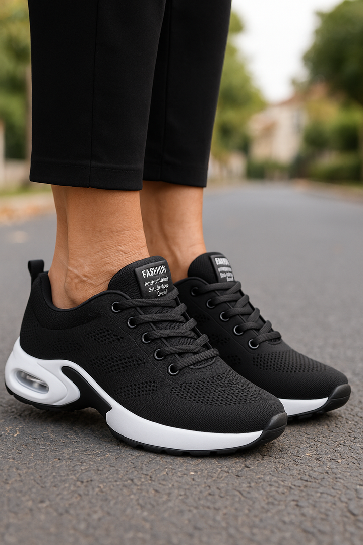 Black knit sneakers with white air-cushion soles.