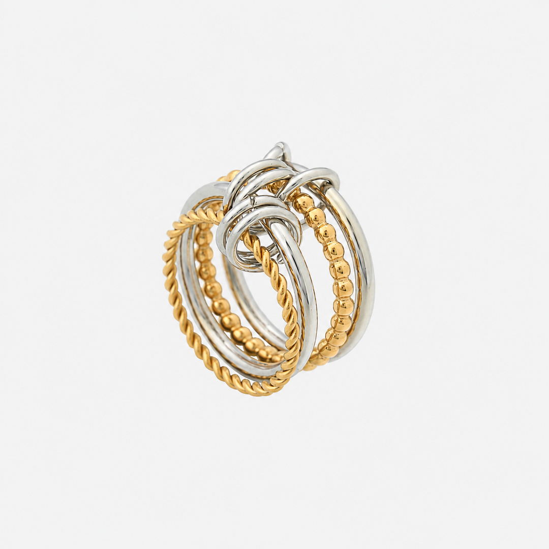 Angled view of the multi-band ring standing upright, showing twisted and beaded gold bands beside silver bands joined by small loops. 2