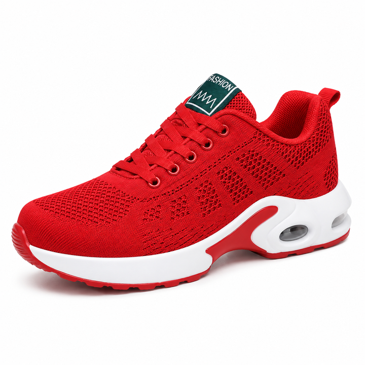 Side view of a bright red mesh sneaker with matching laces, a thick white midsole and a clear heel air cushion. 3