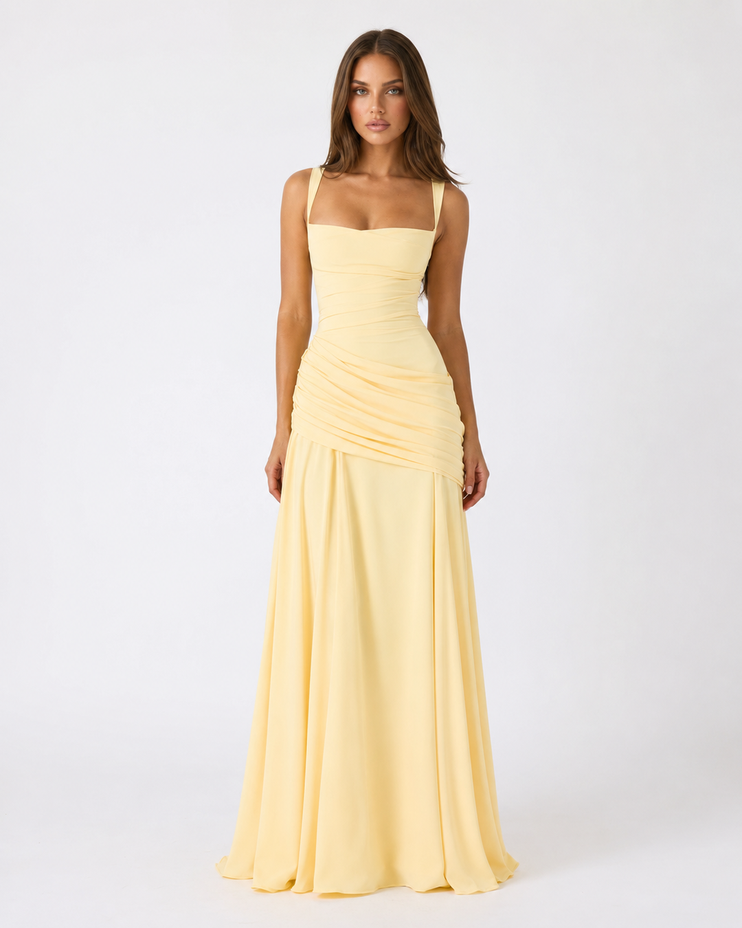Model faces the camera in the pale yellow maxi dress with draped hip ruching and wide straps 1