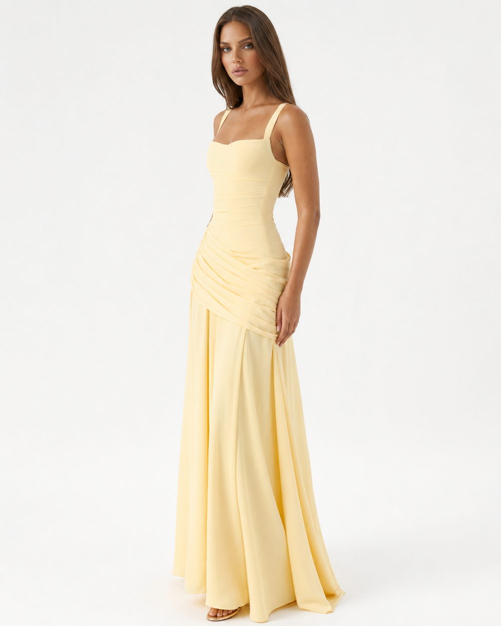 Pale yellow dress seen from a three-quarter angle, showing the gathered hip drape and flowing skirt 2