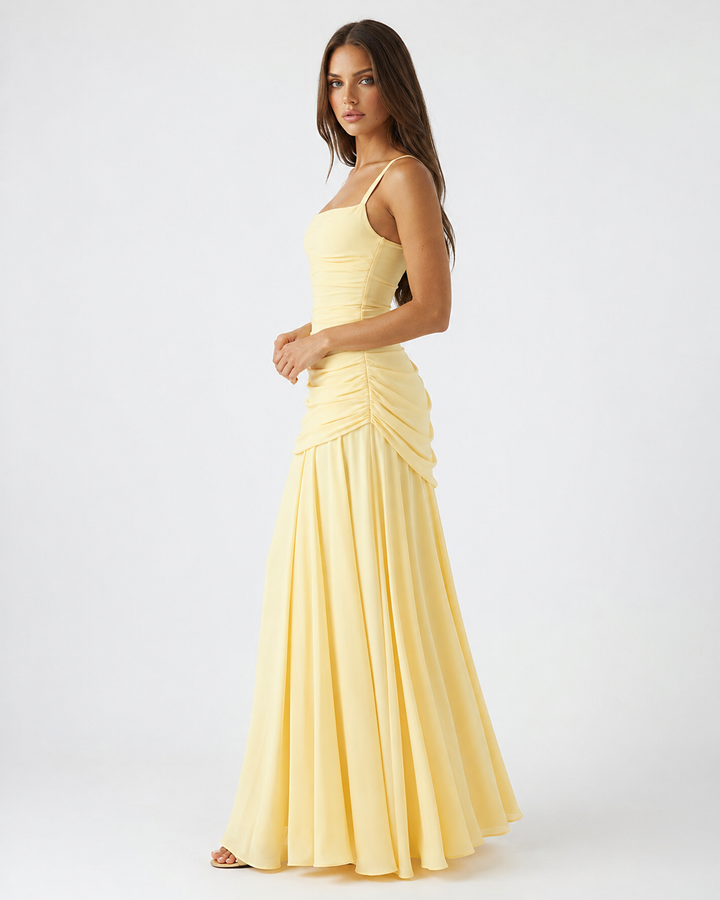 Side view of a green maxi dress with square neck and ruched side gathering on the waist