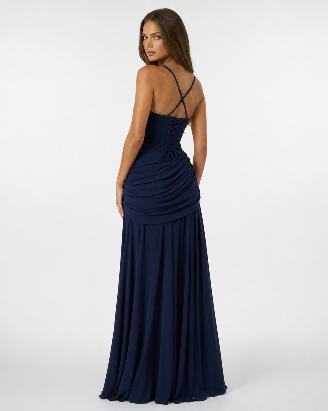 Back of the navy dress, with crisscross straps, lace-up corset back and asymmetric draped hip detail. 8