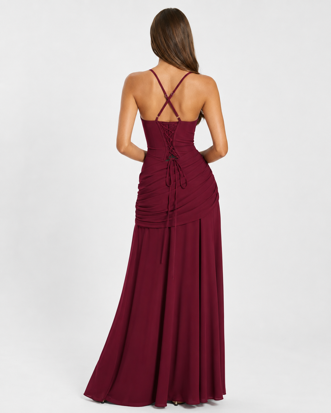 Back view of a burgundy maxi dress showing crossed straps, lace-up corset back and gathered hip detail