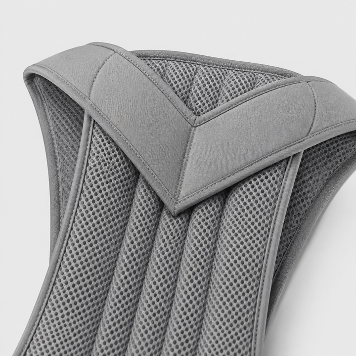 Close-up of the gray brace's padded V-shaped shoulder section and ribbed perforated mesh panel 11