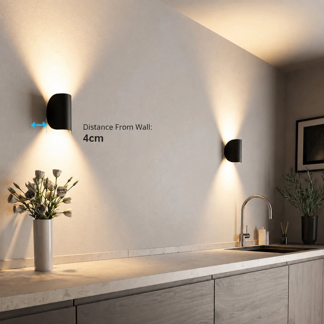 Black wall light in a kitchen with an arrow marking its distance from the wall, a second wall light nearby.
