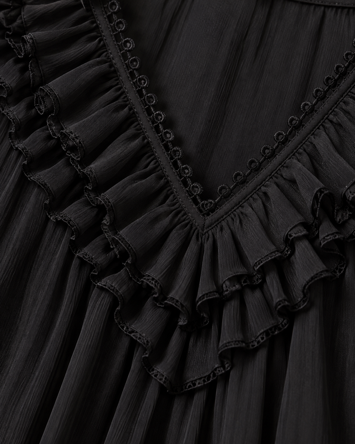 Close-up detail of the black V-neckline with layered chiffon ruffles and a looped lace trim along the edge. 5