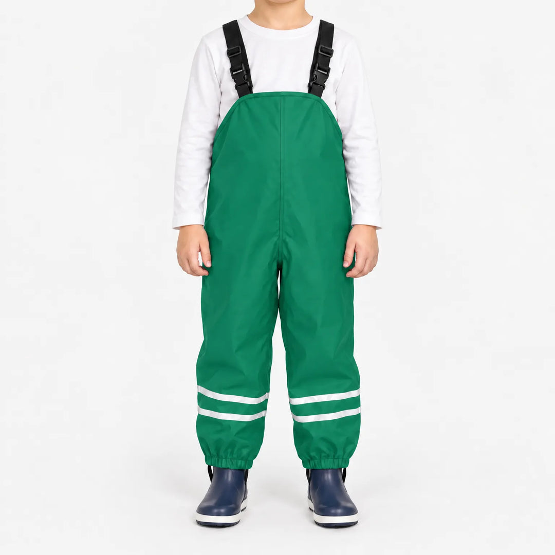 Front view of child wearing green waterproof overalls with black buckled straps, reflective ankle stripes and elastic cuffs, with navy boots. 10