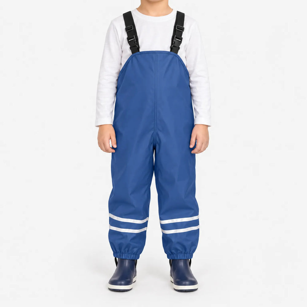 Front view of blue waterproof overalls with adjustable black buckled straps and reflective stripes at the ankles, worn with navy rain boots. 2