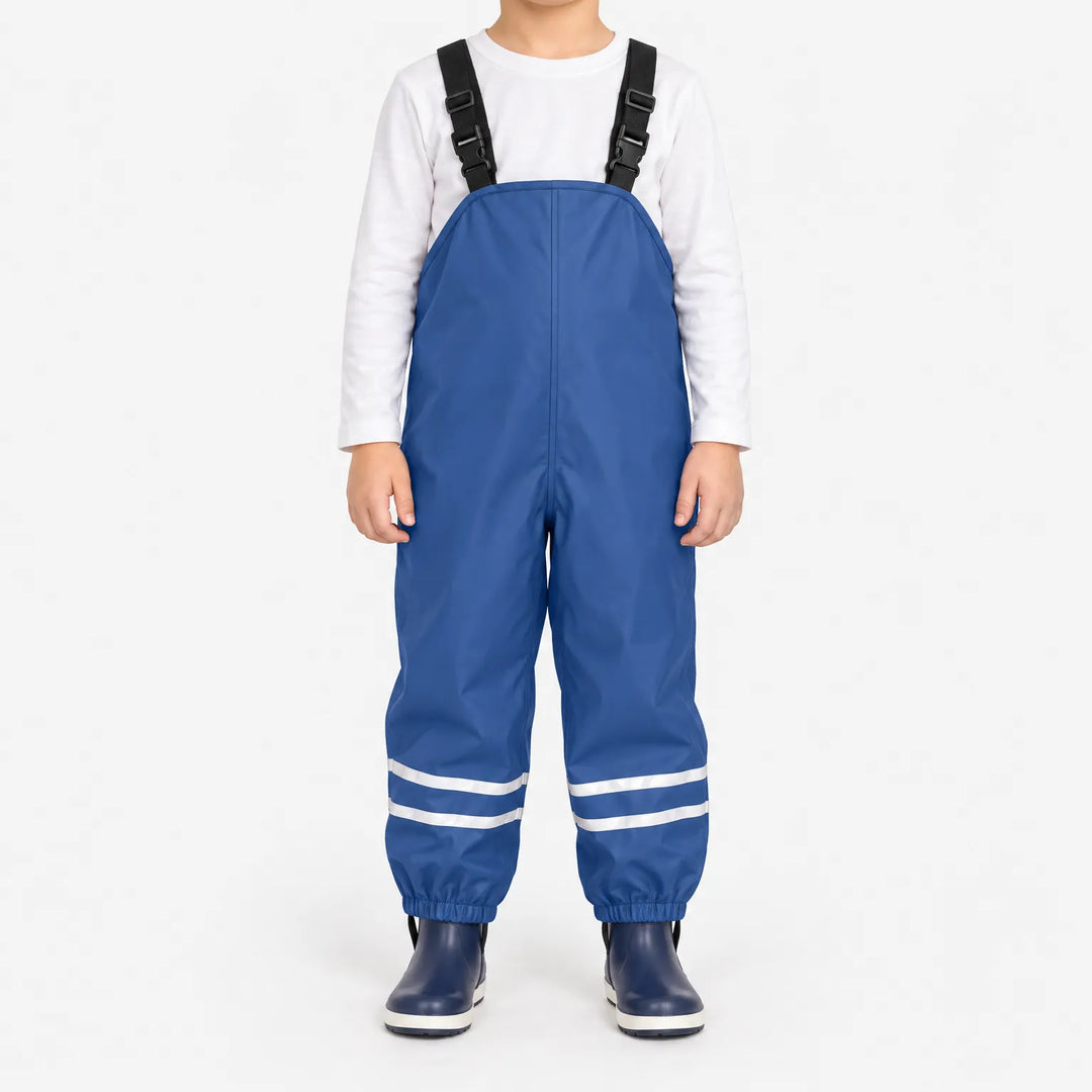 Front view of blue waterproof overalls with adjustable black buckled straps and reflective stripes at the ankles, worn with navy rain boots. 2