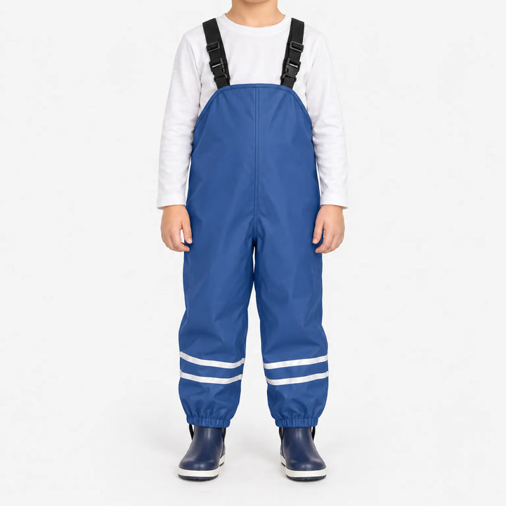 Front view of blue waterproof overalls with adjustable black buckled straps and reflective stripes at the ankles, worn with navy rain boots. 2