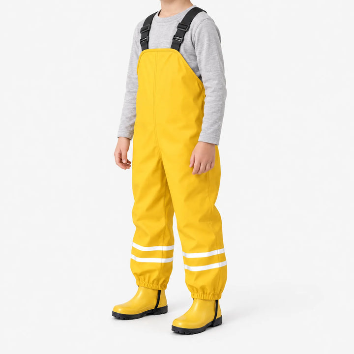 Three-quarter side view of a child in yellow waterproof overalls with reflective ankle stripes, elastic cuffs and matching yellow rain boots. 5
