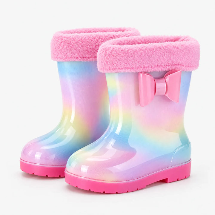 Pair of rainbow rain boots with a plush pink fleece cuff and a pink bow on the outer side. 9