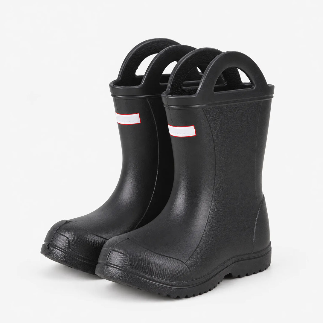 Angled three-quarter view of a pair of black rain boots with handles, showing the textured toe cap and tread sole. 5
