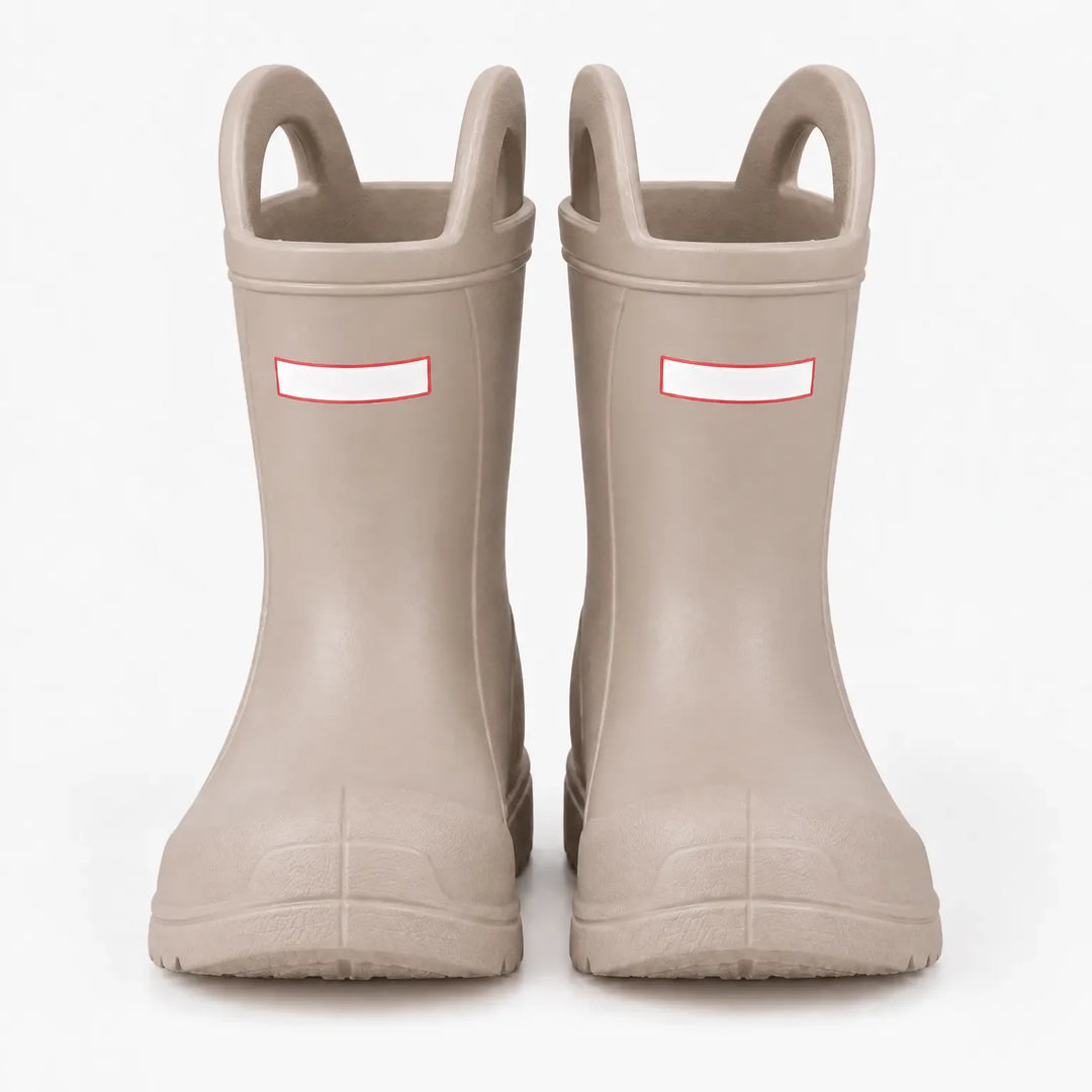 Front view of a pair of beige rain boots with top handles and a molded rubber toe cap. 7