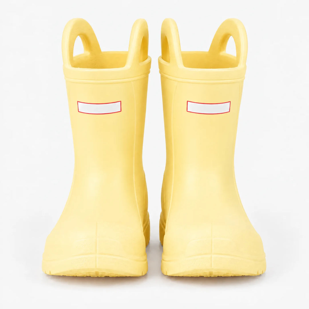 Front view of a pair of pale yellow rain boots with top handles on a white background. 9