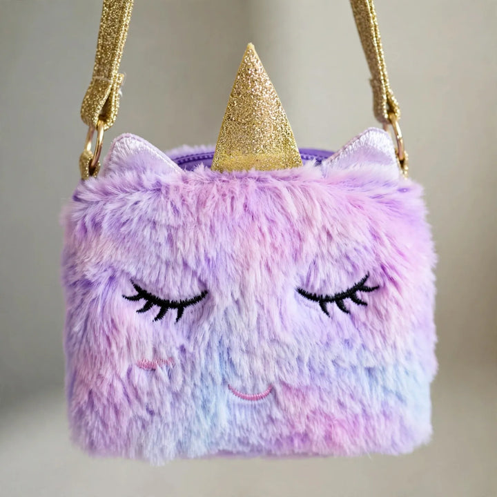 Close-up of a fluffy purple and pink unicorn crossbody bag with a glittery gold horn and strap 3