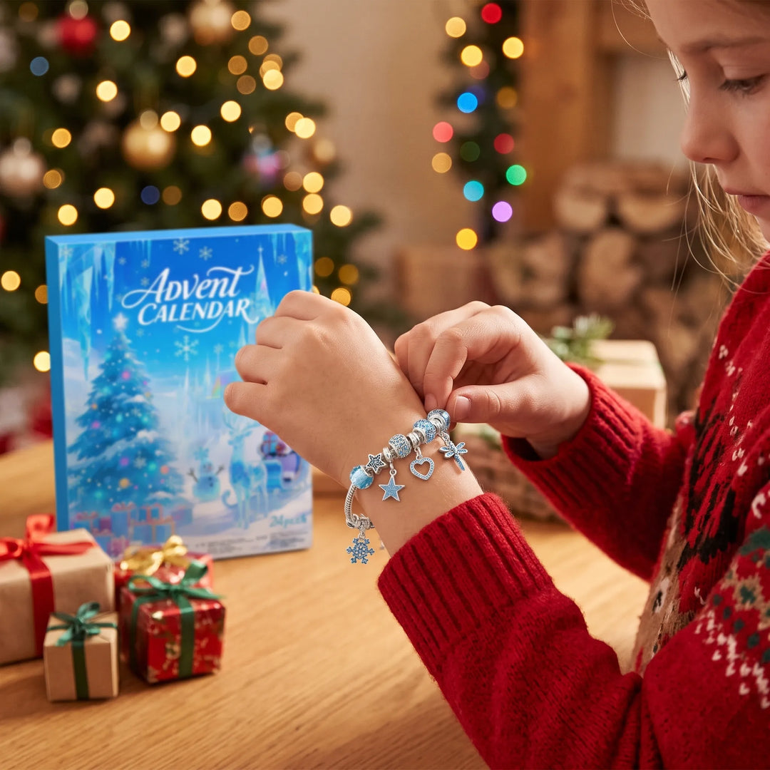 Girl in a red sweater fastens a blue charm bracelet beside the box and Christmas tree 1