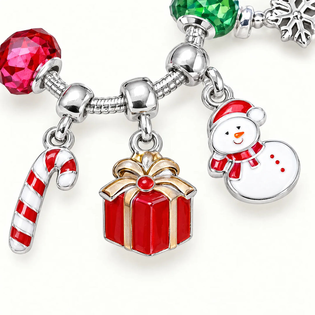 Close-up of a bracelet showing enameled candy cane, red gift box and snowman charms between faceted red and green glass beads. 3