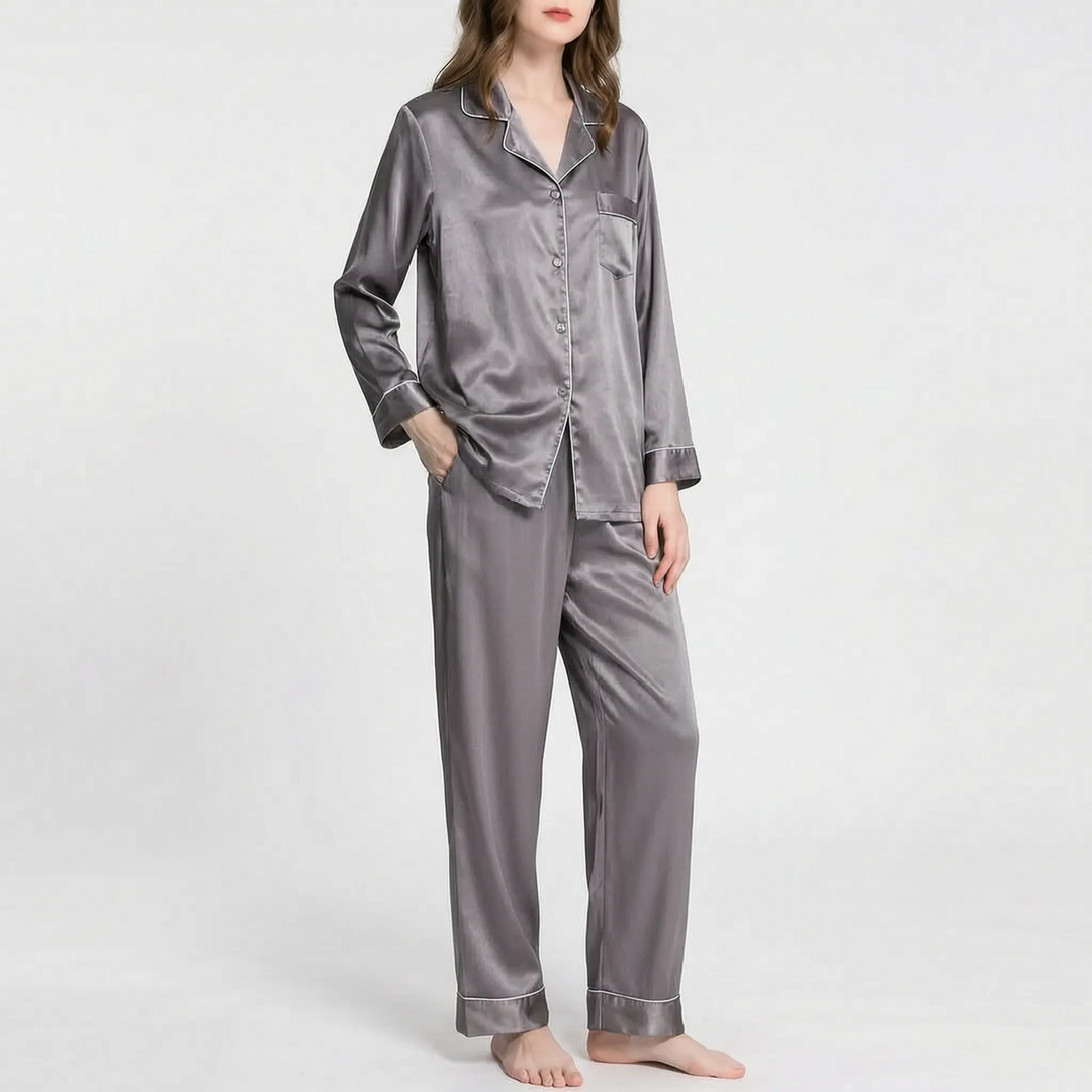 Model wearing the gray satin pajama set with light piping, buttoned long-sleeved shirt and matching wide-leg pants. 14