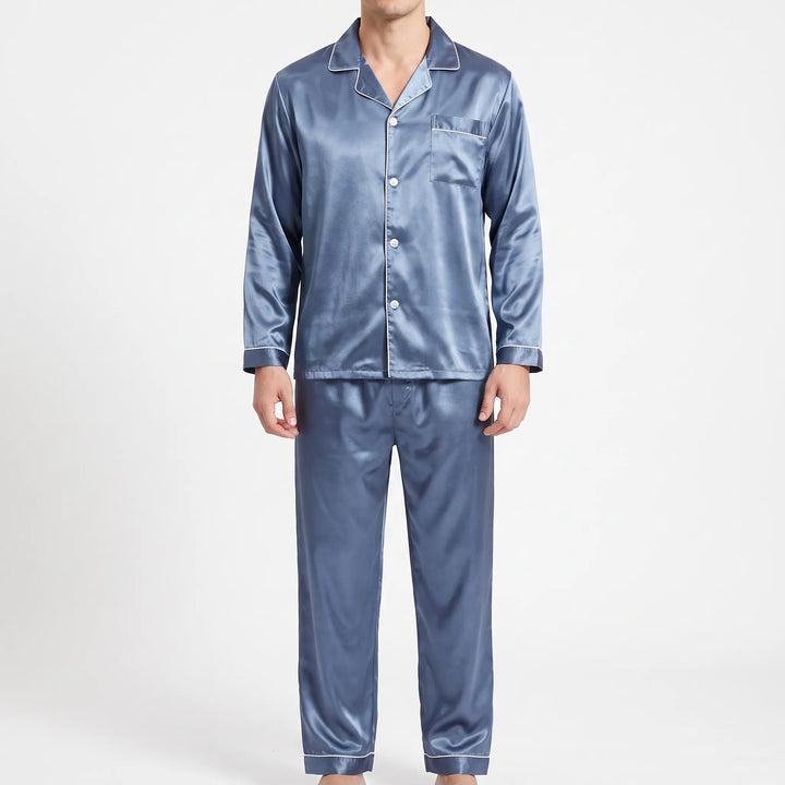 Man wearing the pajama set in a lighter slate blue satin with white piping, shown from the front. 6