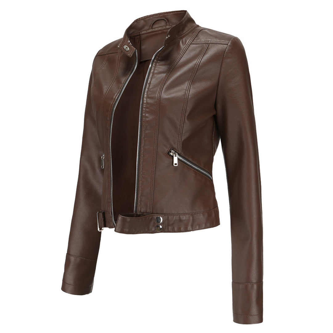 Dark brown cropped jacket in three-quarter view, open at the front, showing stand collar, angled zipper pocket and waist tab. 11