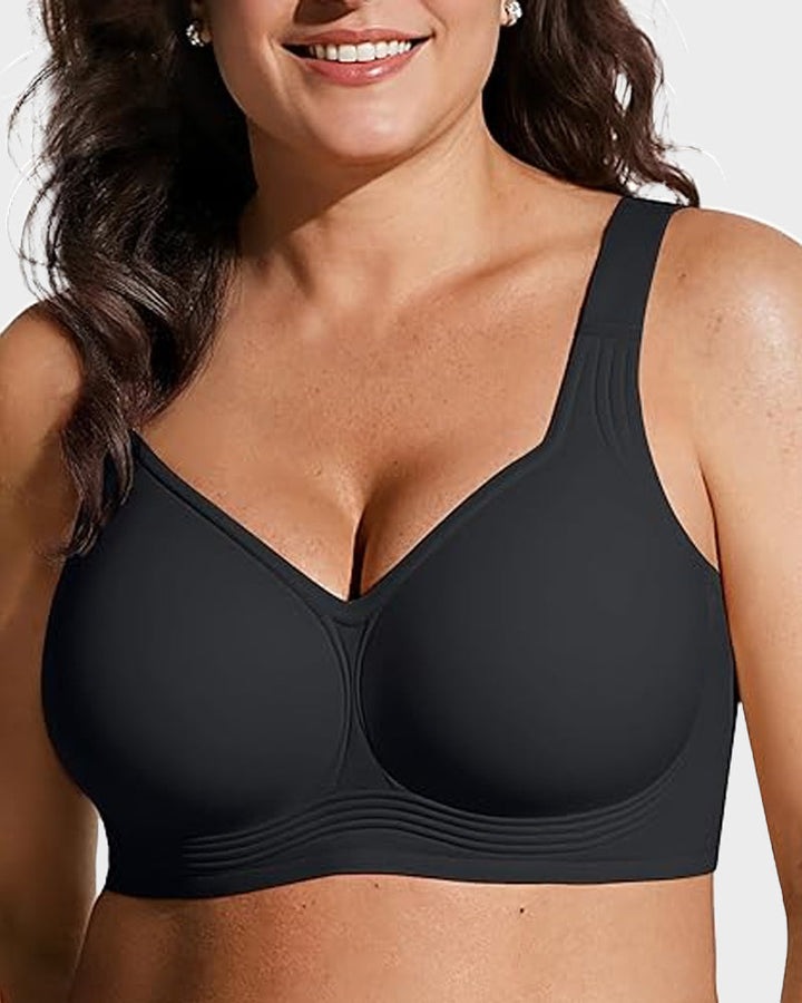 Smiling model wearing the solid black bra, angled view showing the molded cups and curved seam lines. 7
