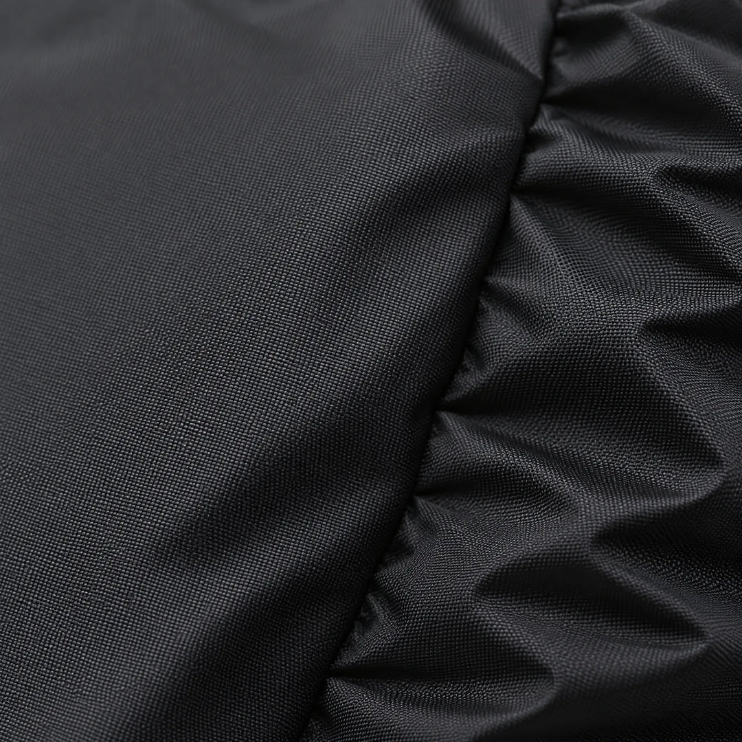 Close-up of the black rain cover fabric showing its fine woven texture and gathered, ruched edge. 5