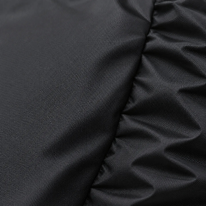 Close-up of the black rain cover fabric showing its fine woven texture and gathered, ruched edge. 5