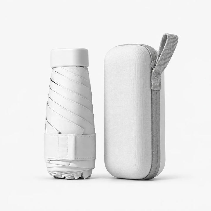 Folded white umbrella with cap and strap beside the matching white zippered hard case with a gray carrying loop. 10