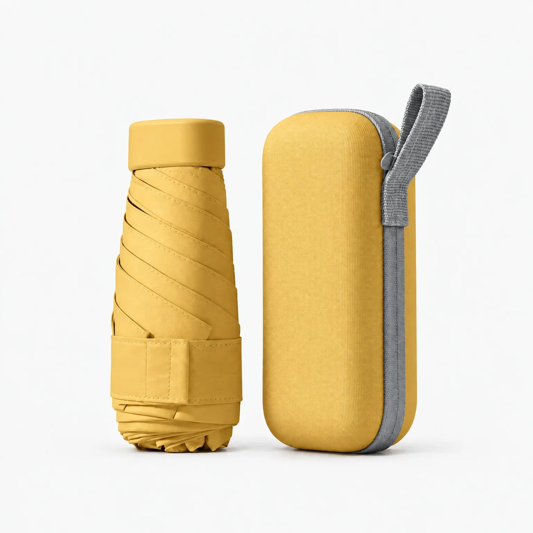 Folded mustard yellow umbrella with cap and strap next to its matching yellow hard case with gray zipper and loop. 11