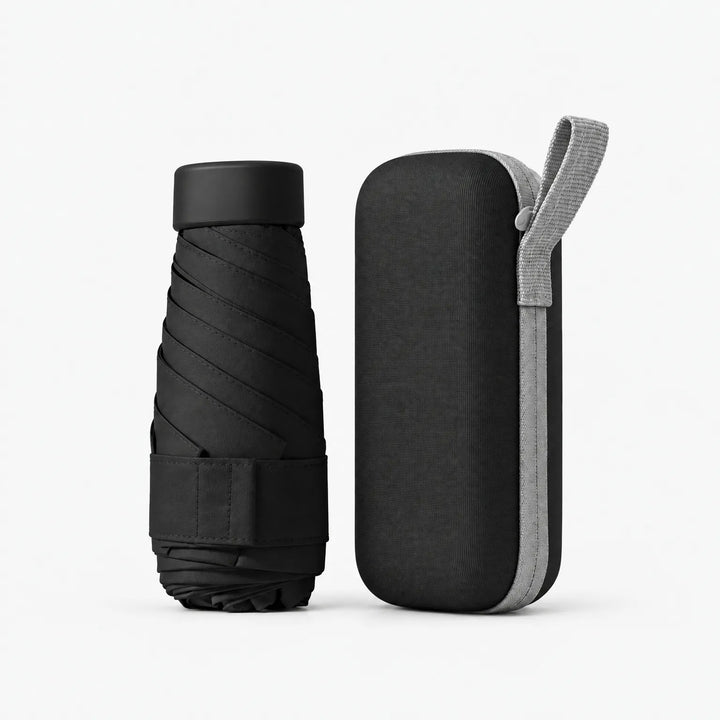 Folded black umbrella with cap and strap beside its matching black zippered hard case with a light gray carrying loop. 12