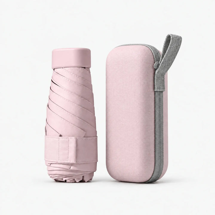 Folded pink umbrella with cap and strap next to its matching pink hard zipper case with a gray carrying loop. 9