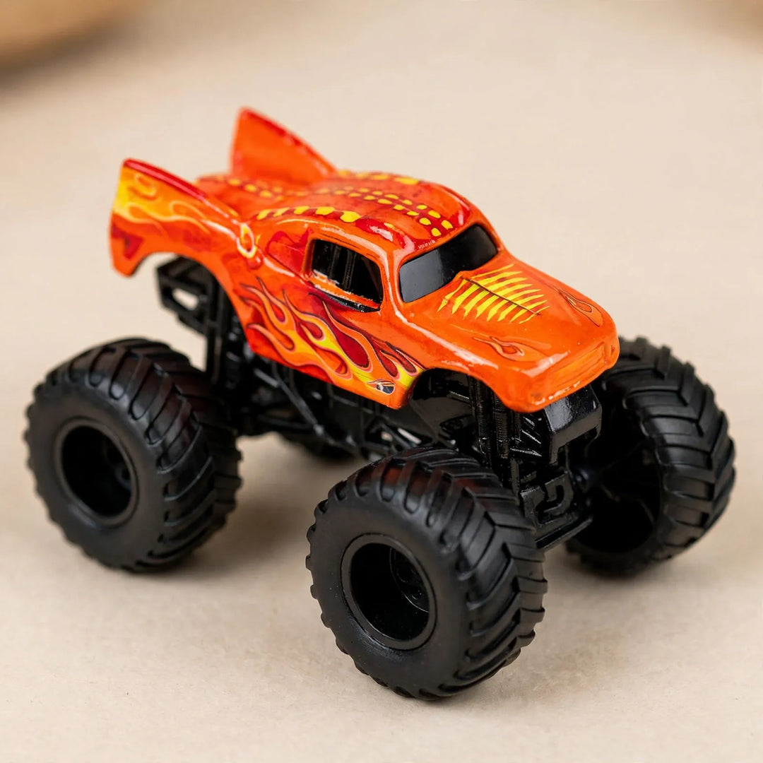 Close-up of one orange monster truck toy with flame decals, a finned body and big black tires 3