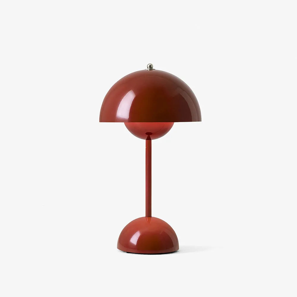 Brick red rechargeable USB table lamp with a metal knob on top against a plain white background.